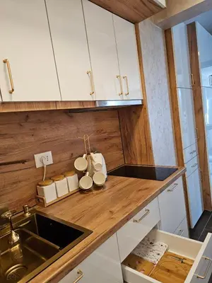 a kitchen with white cabinets and a sink at Apartman KING CENTAR in Vrnjačka Banja