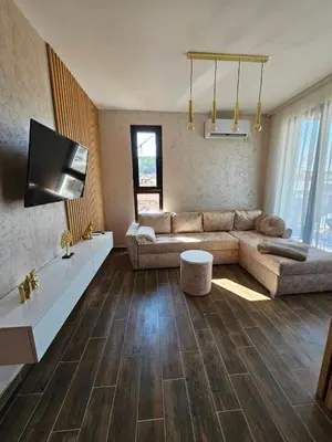 a living room with a couch and a tv at Apartman KING CENTAR in Vrnjačka Banja