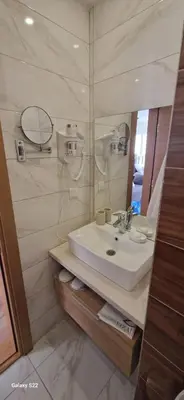 a bathroom with a sink and a mirror at Golden Hour in Kopaonik