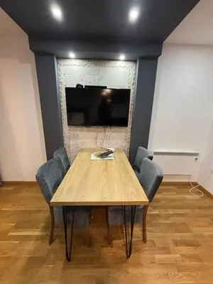 a dining room with a wooden table and chairs at Golden Hour in Kopaonik
