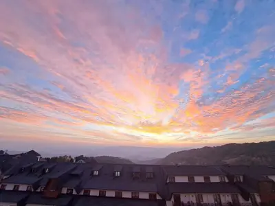 a sunset over roofs of houses in a city at Golden Hour in Kopaonik