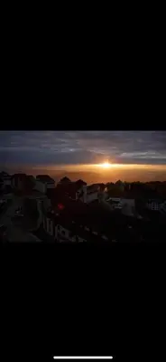 a view of the sunset from a city with buildings at Golden Hour in Kopaonik