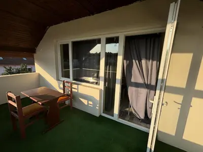 a small balcony with a table and a window at Apartmani Andjeo in Kraljevo