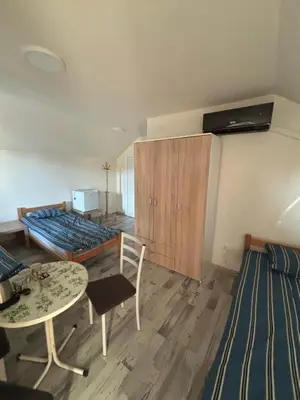 a room with a bed and a table and chairs at Apartmani Andjeo in Kraljevo