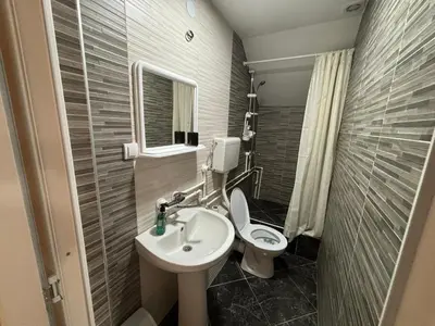 a small bathroom with a toilet and a sink at Apartmani Andjeo in Kraljevo