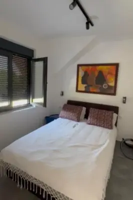 a bedroom with a large white bed with two pillows at Apartman sa pogledom na Ozren in Soko Banja