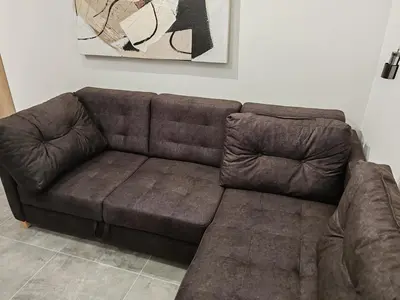 a brown leather couch in a living room at Apartman sa pogledom na Ozren in Soko Banja