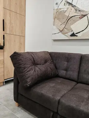 a brown leather couch in a living room at Apartman sa pogledom na Ozren in Soko Banja