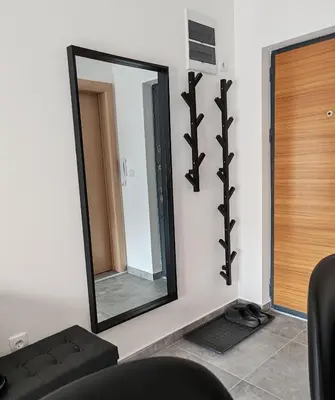 a mirror on a wall in a room at Apartman sa pogledom na Ozren in Soko Banja
