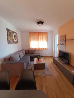a living room with a couch and a tv at Luksuzni Apartman Ema in Pirot