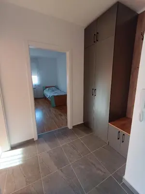 a room with a bed and a room with a closet at Luksuzni Apartman Ema in Pirot