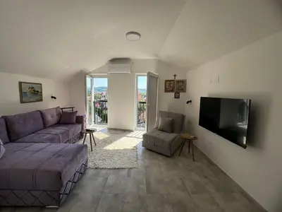 a living room with a couch and a flat screen tv at Vas Dom in Soko Banja
