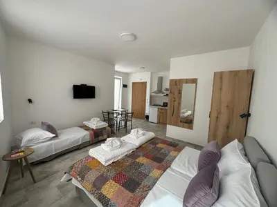 a living room with two beds and a couch at Vas Dom in Soko Banja