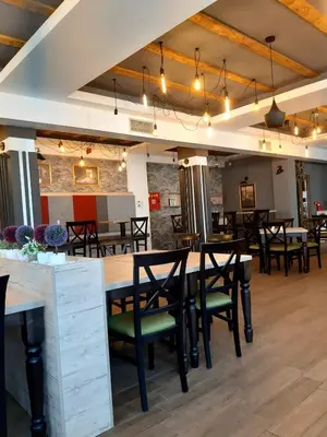 a dining room with wooden tables and chairs at Milmari L39 Kopaonik in Kopaonik
