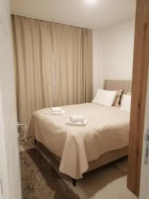 a bedroom with a bed with two towels on it at Husky N in Raška