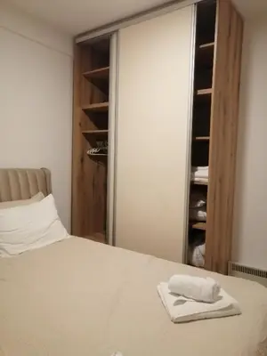 a bedroom with a bed with two towels on it at Husky N in Raška