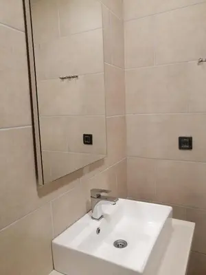 a bathroom with a white sink and a mirror at Husky N in Raška