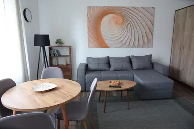 a living room with a couch and two tables at Stan na dan in Paraćin