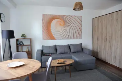 a living room with a couch and a table at Stan na dan in Paraćin
