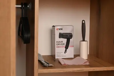 a shelf with a hair dryer and a box on it at Apartmani Timacum in Knjazevac.