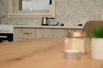 a kitchen with a wooden table and a mirror at Apartmani Timacum in Knjazevac.