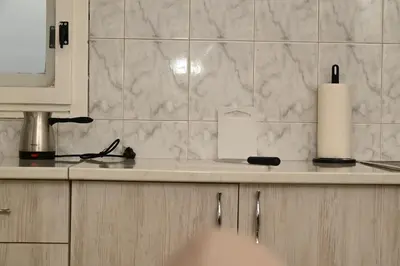 a kitchen with a counter with a candle on it at Apartmani Timacum in Knjazevac.