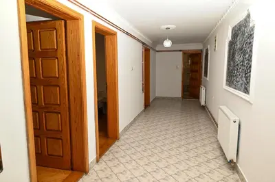 a hallway with a door and a tile floor at Apartmani Timacum in Knjazevac.