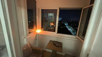 a room with a window with a view of a city at Stan na Dan - Centar - Besplatan parking in Niš