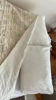 a pair of pillows sitting on top of a bed at Stan na Dan - Centar - Besplatan parking in Niš