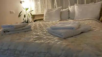 a bed with towels sitting on top of it at Stan na Dan - Centar - Besplatan parking in Niš