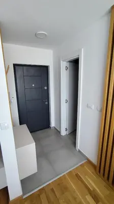 an empty room with a door and a mirror at Apartman Đorđe in Vrnjačka Banja