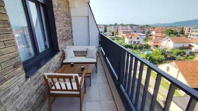 a balcony with chairs and a view of a city at Apartman Đorđe in Vrnjačka Banja