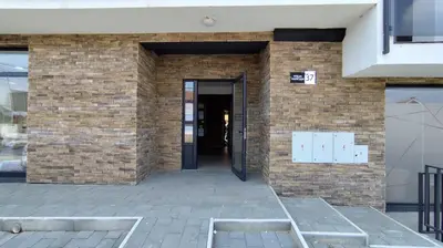 a brick building with a door and a entrance at Apartman Đorđe in Vrnjačka Banja