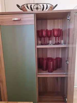 a cupboard with red bowls and bowls in it at Ana LUX in Dobrosin