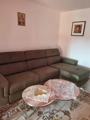 a living room with a brown couch and two tables at Ana LUX in Dobrosin