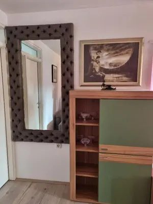 a mirror on a wall in a room with a dresser at Ana LUX in Dobrosin