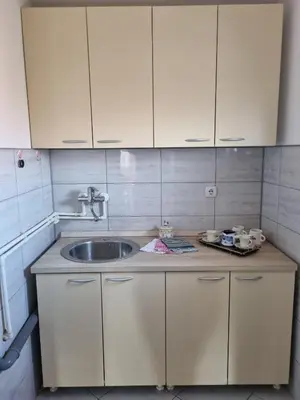 a kitchen with a sink and white cabinets at Ana LUX in Dobrosin