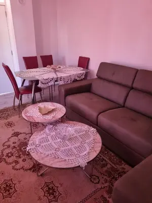a living room with a couch and tables and chairs at Ana LUX in Dobrosin