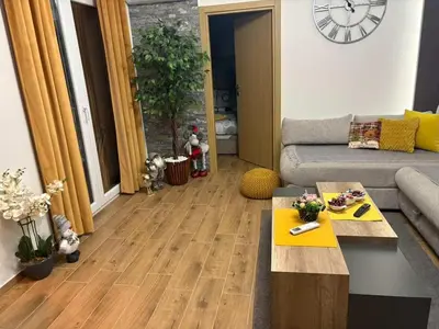 a living room with a couch and a table at SOUL Apartman in Soko Banja