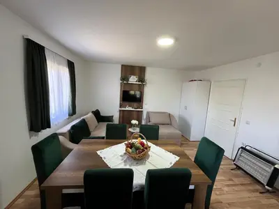a living room with a table and a couch at Vikendica Bellini 3 in Soko Banja