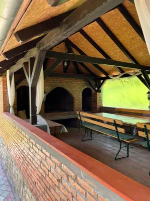 a patio with benches and a brick wall at Vikendica Bellini 3 in Soko Banja