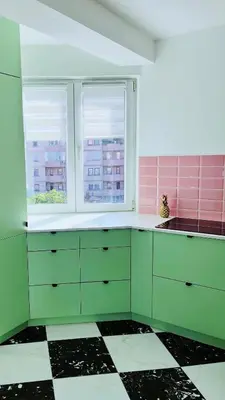 a kitchen with green cabinets and a checkered floor at Happy Place Apartment Pirot in Pirot