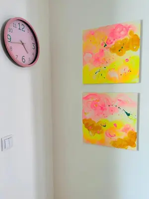 a clock on a wall with a painting and a picture at Happy Place Apartment Pirot in Pirot