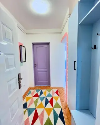 a room with a purple door and a colorful floor at Happy Place Apartment Pirot in Pirot