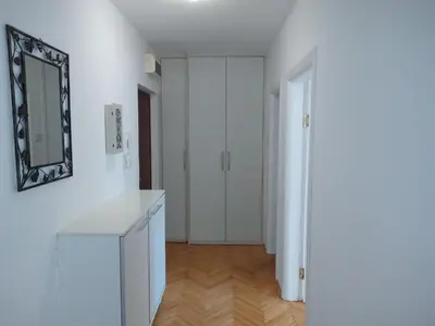 a white bathroom with a mirror and white cabinets at Aqua 11 big apartment in Jagodina