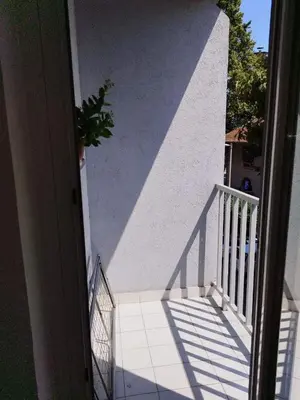 a stairway with a potted plant on the side of a building at Aqua 11 big apartment in Jagodina