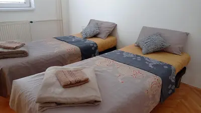a room with three beds with blankets and towels at Aqua 11 big apartment in Jagodina
