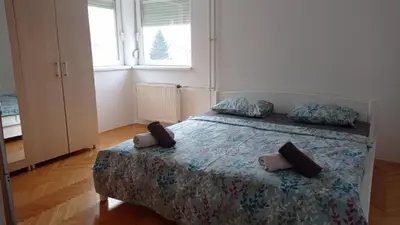 a bedroom with a bed with two pillows on it at Aqua 11 big apartment in Jagodina