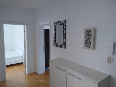a white room with a mirror on a wall at Aqua 11 big apartment in Jagodina