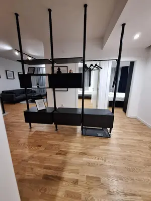 a room with two bunk beds and a wooden floor at Brooklyn88 Apartment in Niš